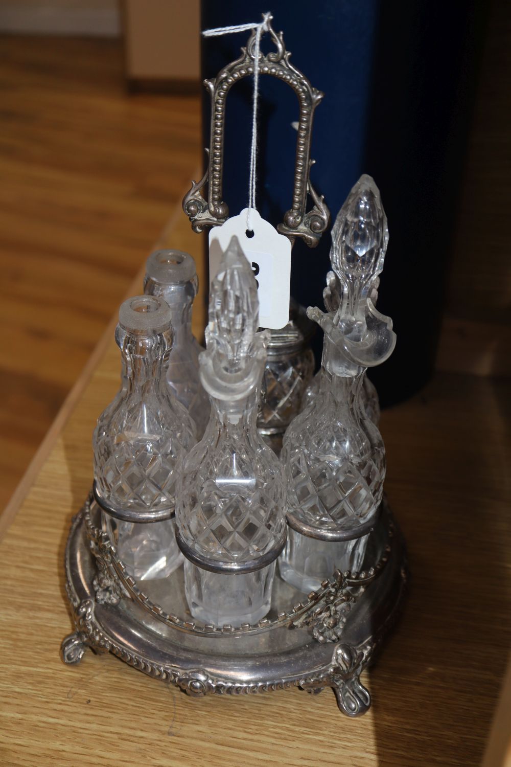 A Victorian plated cruet and a 19th century mahogany and mother of pearl inlaid decanter box, six fitted decanters, one associated stop